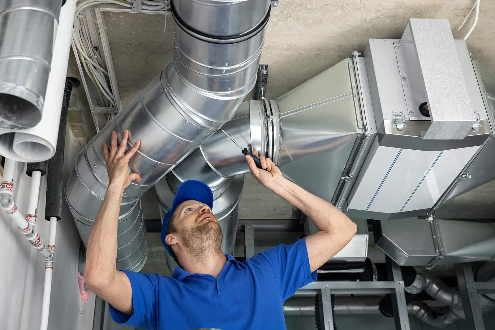 HVAC technician inspecting and repairing air ducts in Santa Clarita