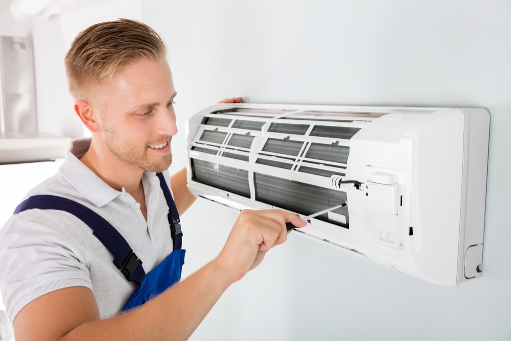HVAC technician maintaining a ductless air conditioner in Santa Clarita