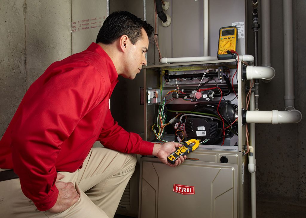 Heating technician diagnosing a furnace repair in Santa Clarita