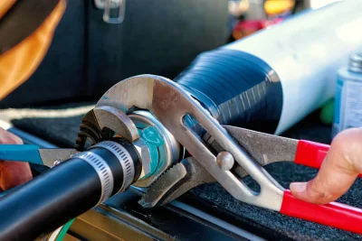 Technician repairing an industrial pipe connection in Santa Clarita