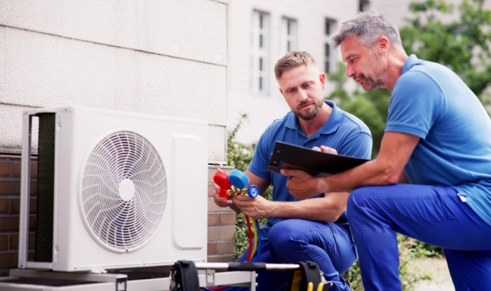 HVAC technicians installing an outdoor air conditioning unit in Santa Clarita