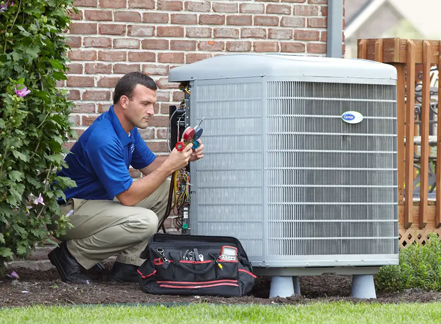 HVAC technician inspecting an outdoor AC unit in Santa Clarita