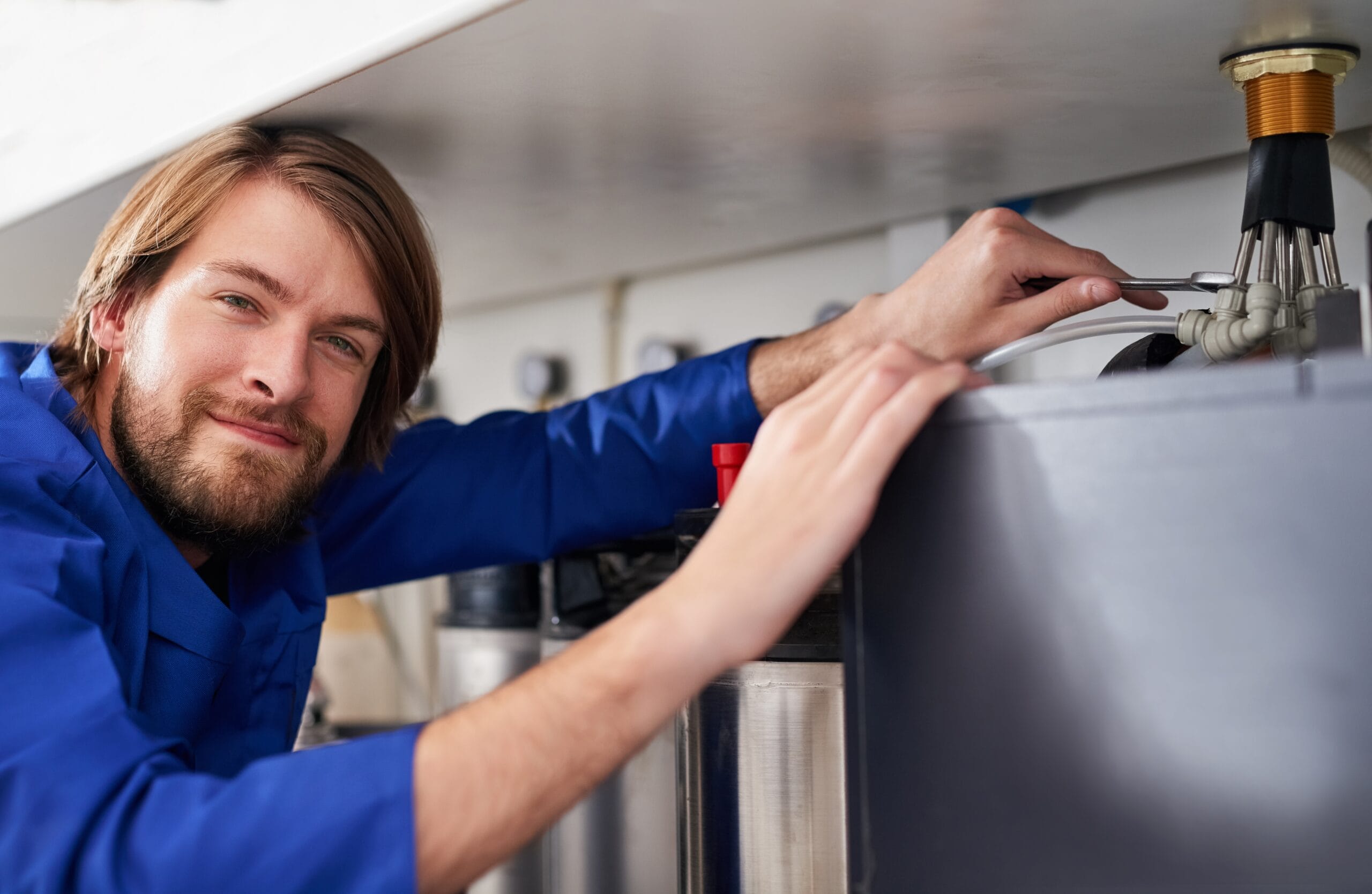 Technician servicing a residential water heater tank in Santa Clarita